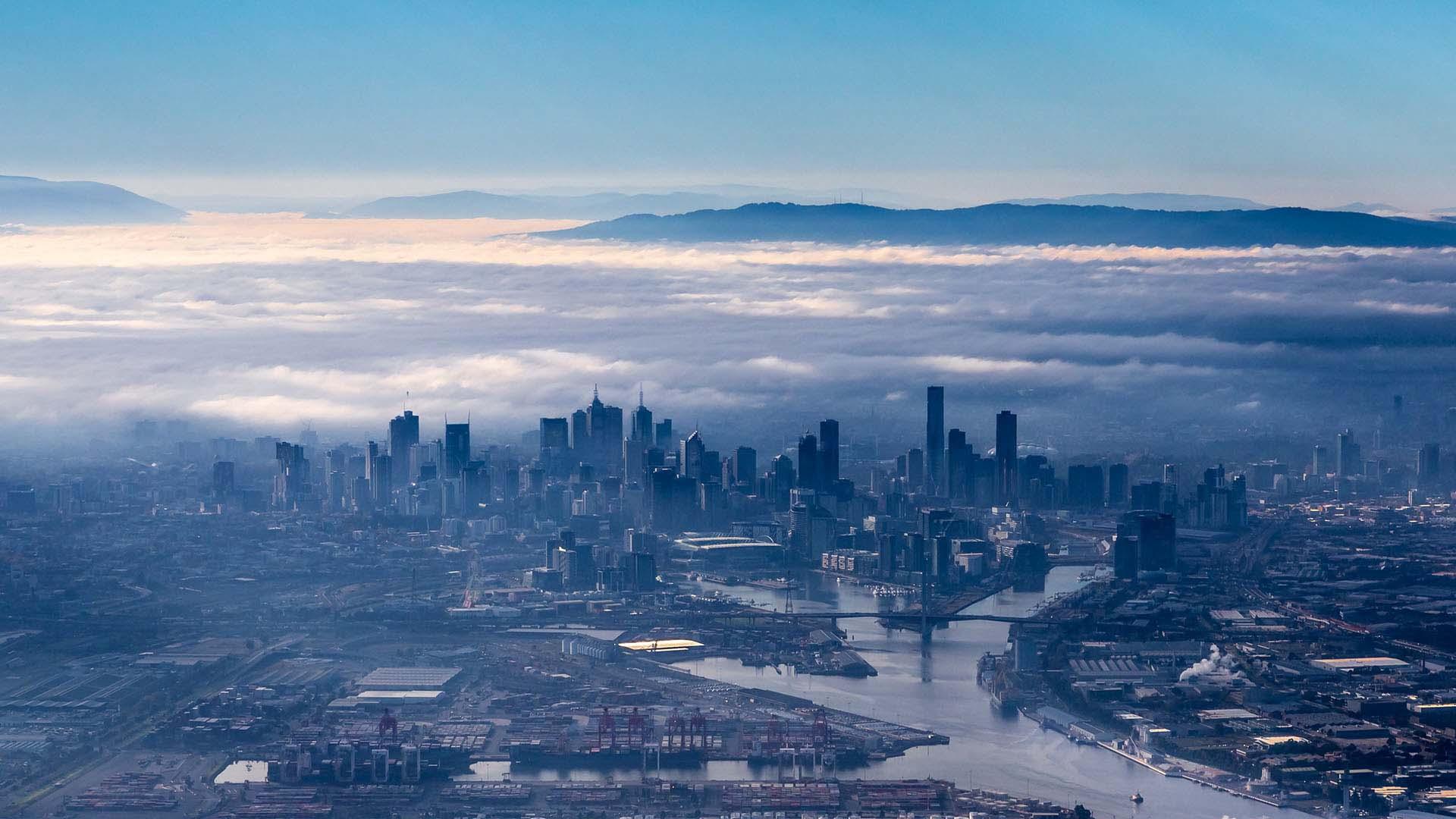 a city scape with clouds behind